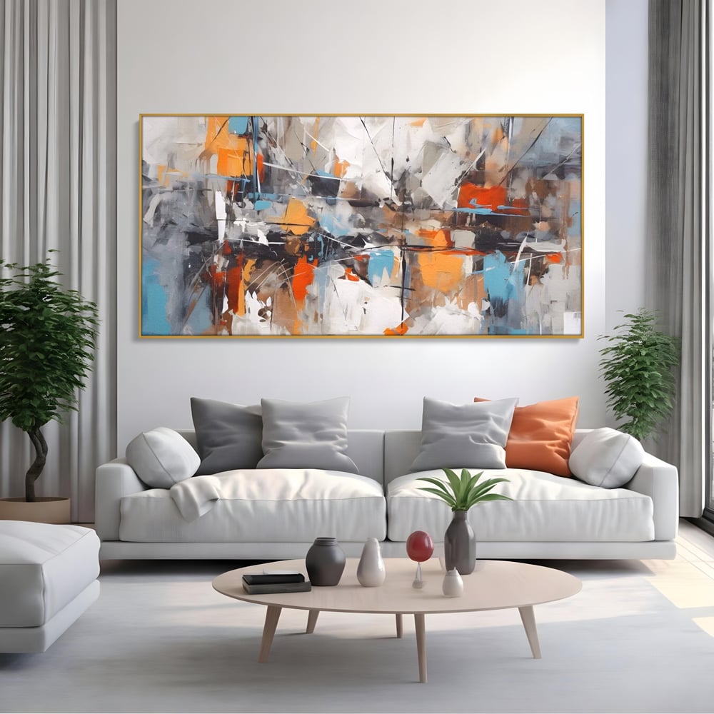 Tablou canvas cu pictura abstracta cu pete portocalii, in rama de aluminiu auriu, pe perete intr-un living